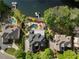 Aerial view of a luxury home with a pool and boat dock on the lake, surrounded by lush landscaping and mature trees at 1145 Lake Shore Overlook, Alpharetta, GA 30005