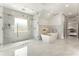 Luxurious bathroom featuring a glass-enclosed shower, soaking tub, and sleek modern fixtures at 1145 Lake Shore Overlook, Alpharetta, GA 30005