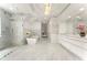 Luxurious bathroom featuring a glass-enclosed shower, soaking tub, marble flooring, and dual vanity sinks at 1145 Lake Shore Overlook, Alpharetta, GA 30005