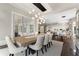 Bright dining room with modern chandelier, dining table, seating for six, and sliding doors to a patio at 1145 Lake Shore Overlook, Alpharetta, GA 30005