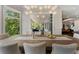 Open dining room with floor to ceiling windows and seating for six at 1145 Lake Shore Overlook, Alpharetta, GA 30005