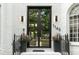 Elegant home entrance featuring a modern black framed glass double door and black metal railings at 1145 Lake Shore Overlook, Alpharetta, GA 30005