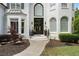 Charming two-story home with beautiful brick exterior, arched windows and landscaped front yard at 1145 Lake Shore Overlook, Alpharetta, GA 30005