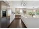 Modern kitchen with sleek white cabinetry, stainless steel appliances, and dark wood flooring for a sophisticated culinary space at 1145 Lake Shore Overlook, Alpharetta, GA 30005