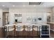 Modern kitchen features bar seating, sleek cabinetry, stainless steel appliances, and a wine refrigerator at 1145 Lake Shore Overlook, Alpharetta, GA 30005