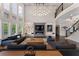 Luxurious living room with high ceilings, a modern fireplace, and a comfortable seating area, perfect for relaxation at 1145 Lake Shore Overlook, Alpharetta, GA 30005