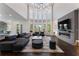 Grand living room boasts high ceilings, modern fireplace, large windows and luxurious furnishings at 1145 Lake Shore Overlook, Alpharetta, GA 30005