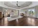 Spacious main bedroom features a tray ceiling, hardwood floors, and large windows with bright natural light at 1145 Lake Shore Overlook, Alpharetta, GA 30005