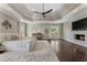 Expansive main bedroom with fireplace, tray ceiling, and hardwood floors offers luxury and comfort at 1145 Lake Shore Overlook, Alpharetta, GA 30005