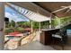 Outdoor bar with seating overlooking a backyard with pool at 1145 Lake Shore Overlook, Alpharetta, GA 30005
