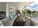 Spacious covered patio with ample seating and a long fire pit table, overlooking a beautiful backyard at 1145 Lake Shore Overlook, Alpharetta, GA 30005