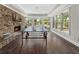 Recreation room with a stone fireplace and scenic backyard views at 1145 Lake Shore Overlook, Alpharetta, GA 30005