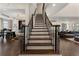 Elegant staircase features dark wood treads and wrought iron spindles, connecting the home's open-concept living spaces at 1145 Lake Shore Overlook, Alpharetta, GA 30005