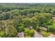 Aerial view of a home surrounded by lush greenery and mature trees in a residential neighborhood at 218 Deerwood Se Ct, Smyrna, GA 30082