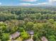 Aerial view of a home surrounded by lush greenery and mature trees in a residential neighborhood at 218 Deerwood Se Ct, Smyrna, GA 30082
