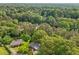 Aerial view of a home surrounded by lush greenery and mature trees in a residential neighborhood at 218 Deerwood Se Ct, Smyrna, GA 30082