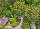 An aerial view of a home with a long driveway and mature trees surrounding the property at 218 Deerwood Se Ct, Smyrna, GA 30082