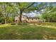 Two-story house surrounded by mature trees and lush greenery at 218 Deerwood Se Ct, Smyrna, GA 30082