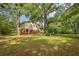 Backyard featuring a two-story house surrounded by mature trees and lush greenery at 218 Deerwood Se Ct, Smyrna, GA 30082