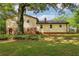 Backyard view of this house featuring a brick foundation and siding at 218 Deerwood Se Ct, Smyrna, GA 30082