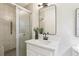 Bathroom vanity with a modern rectangular mirror and a tiled shower with a glass door at 218 Deerwood Se Ct, Smyrna, GA 30082