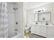 Nicely renovated bathroom showcasing a sleek white vanity, tub with tile surround and modern lighting at 218 Deerwood Se Ct, Smyrna, GA 30082