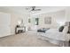 Nicely staged bedroom with warm carpet, ceiling fan and side access to the bathroom at 218 Deerwood Se Ct, Smyrna, GA 30082