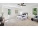 Well-lit bedroom featuring cozy decor, a ceiling fan, and tranquil outdoor views from windows at 218 Deerwood Se Ct, Smyrna, GA 30082