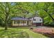 Charming home featuring a covered front porch, manicured lawn and attached garage at 218 Deerwood Se Ct, Smyrna, GA 30082