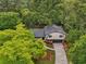 Charming home nestled among mature trees with well-maintained landscaping and a driveway at 218 Deerwood Se Ct, Smyrna, GA 30082