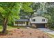 Charming home featuring a covered front porch, manicured lawn and attached garage at 218 Deerwood Se Ct, Smyrna, GA 30082