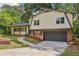 Charming home featuring a covered front porch, manicured lawn and attached garage at 218 Deerwood Se Ct, Smyrna, GA 30082