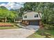 Charming home featuring a covered front porch, manicured lawn and attached garage at 218 Deerwood Se Ct, Smyrna, GA 30082