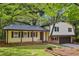 Charming home featuring a covered front porch, manicured lawn and attached garage at 218 Deerwood Se Ct, Smyrna, GA 30082