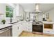 Bright kitchen featuring stainless steel appliances, white cabinets, and modern sink fixtures at 218 Deerwood Se Ct, Smyrna, GA 30082