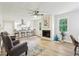 Bright living room featuring a fireplace, open kitchen, and hardwood floors at 218 Deerwood Se Ct, Smyrna, GA 30082