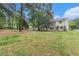 Expansive backyard featuring green grass and mature trees adding privacy to the home's exterior at 2320 Crystal Ct, Loganville, GA 30052