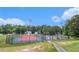Outdoor basketball and tennis courts surrounded by lush trees, perfect for recreation at 2320 Crystal Ct, Loganville, GA 30052