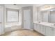 Bright bathroom with double vanity, and separate soaking tub at 2320 Crystal Ct, Loganville, GA 30052