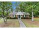 Charming clubhouse featuring brick exterior, green shutters and landscaping with a sidewalk entry at 2320 Crystal Ct, Loganville, GA 30052