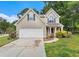 Charming two-story home features a two-car garage and beautiful landscaping at 2320 Crystal Ct, Loganville, GA 30052