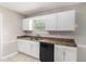 Kitchen boasts stainless sink, dishwasher, and white cabinets at 2320 Crystal Ct, Loganville, GA 30052