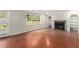 Bright living room featuring hardwood floors, fireplace, and built-in shelves at 2320 Crystal Ct, Loganville, GA 30052