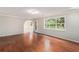 Bright living room featuring hardwood floors and a large window with a backyard view at 2320 Crystal Ct, Loganville, GA 30052