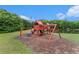 Community playground with swings, slides and lake in the background, perfect for outdoor Gathering fun at 2320 Crystal Ct, Loganville, GA 30052