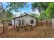 The backyard features a fenced yard with a wooden deck and access through elegant french doors at 235 Holly Nw Rd, Atlanta, GA 30314