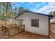View of the backyard featuring a wooden deck, white siding, and a newly installed window at 235 Holly Nw Rd, Atlanta, GA 30314