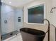 Modern bathroom with a black freestanding tub and glass-enclosed tiled shower at 235 Holly Nw Rd, Atlanta, GA 30314