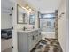 Bright bathroom featuring a double sink vanity with a unique tile floor and glass enclosed shower at 235 Holly Nw Rd, Atlanta, GA 30314