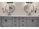 Bathroom with a double sink vanity, marble countertop, round mirrors, and modern lighting at 235 Holly Nw Rd, Atlanta, GA 30314